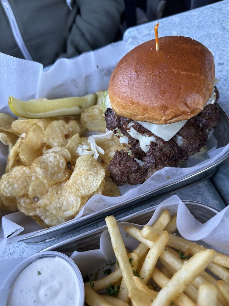 House burger with fries and chips on a Logan's Alley tray